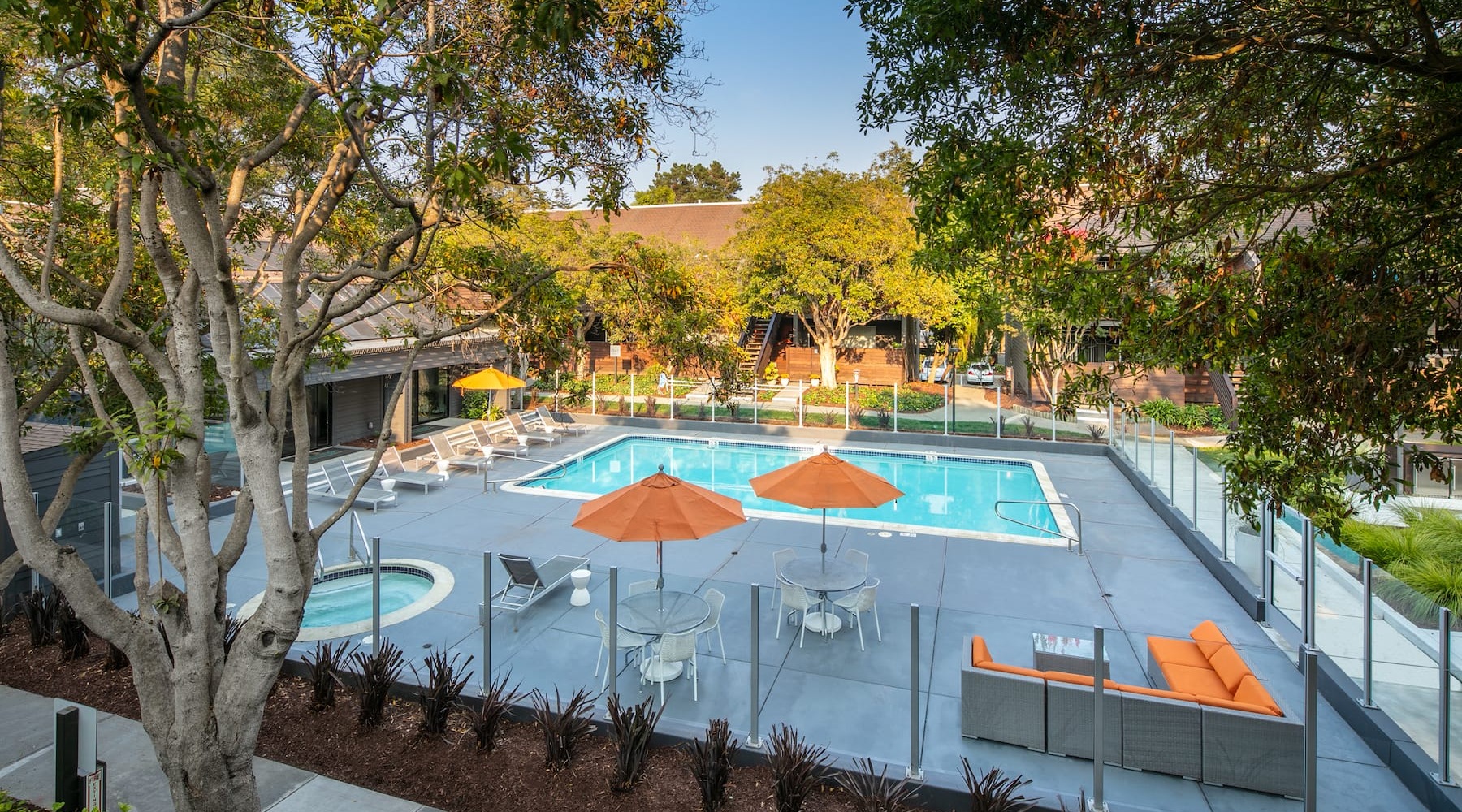 Spacious sparkling pool with sundecks and cabanas for lounging.
